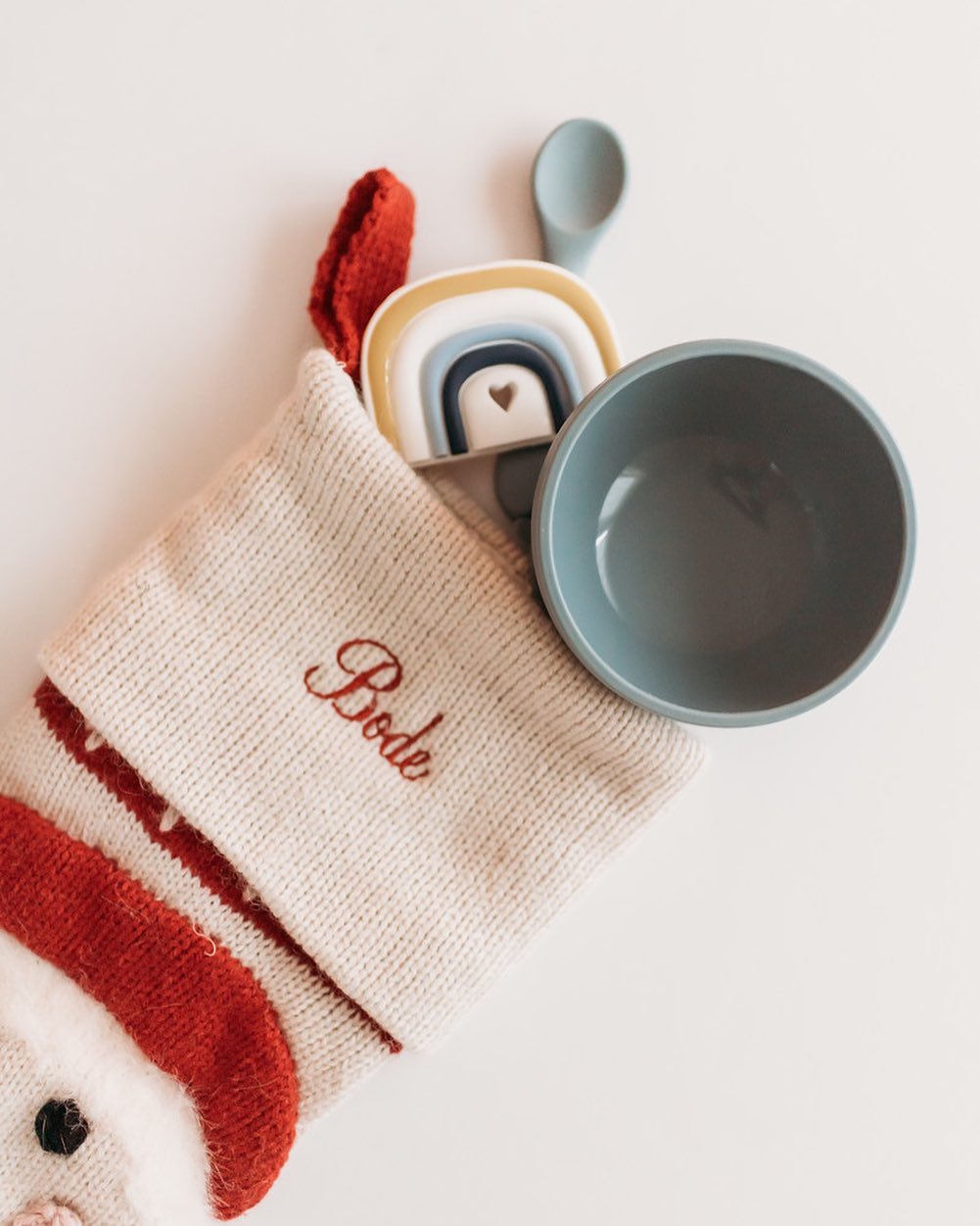 Christmas stocking with the Teal meal half moon bowl, spoon, and rainbow teether
